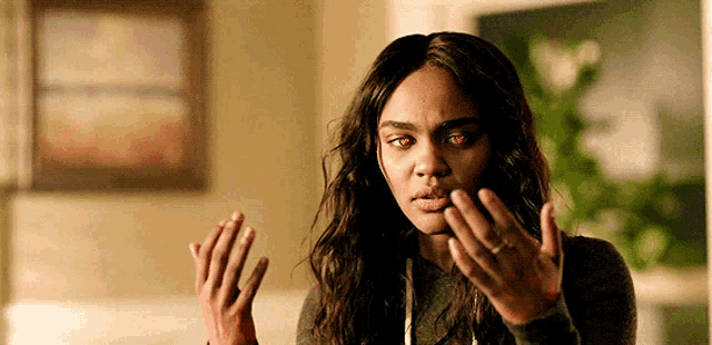 a woman is wearing a pair of bloody gloves and making a funny face .