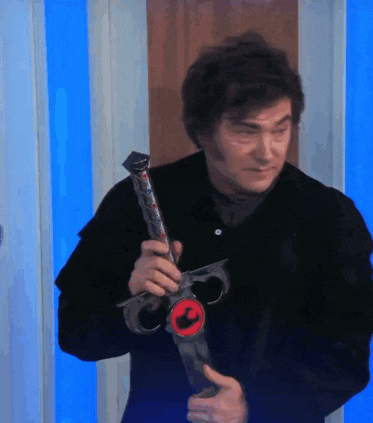 a man in a black jacket is holding a sword with the letter c on it