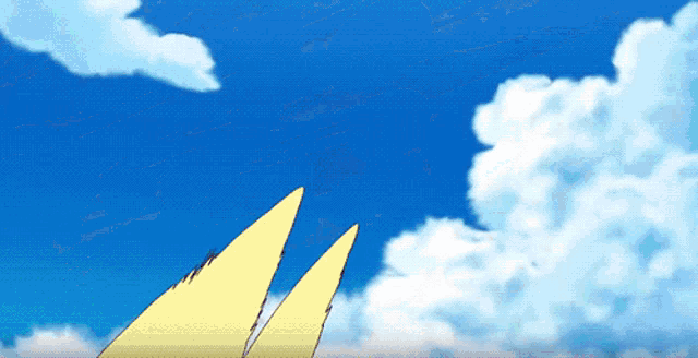 a blue sky with white clouds and two yellow sails in the foreground