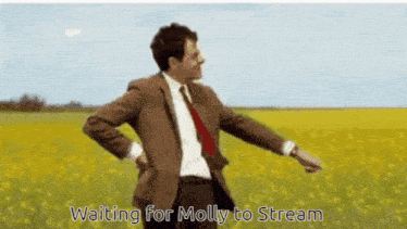 a man in a suit and tie is standing in a field with the words " waiting for molly to stream " on the bottom