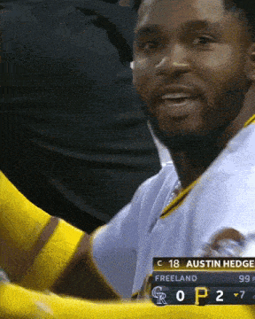 a baseball player named austin hedge is wearing a white jersey