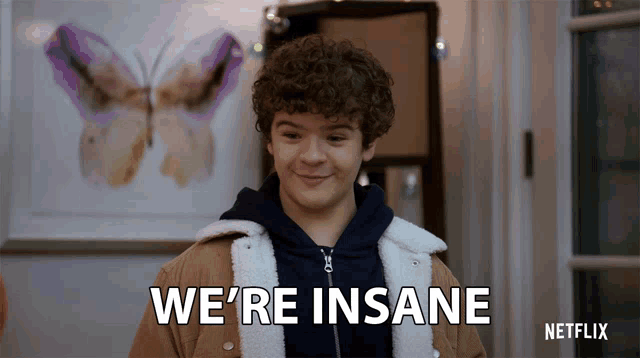 a man says we 're insane in front of a butterfly picture