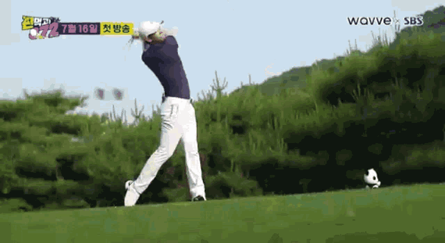 a man is swinging a golf club on a golf course sponsored by woovve