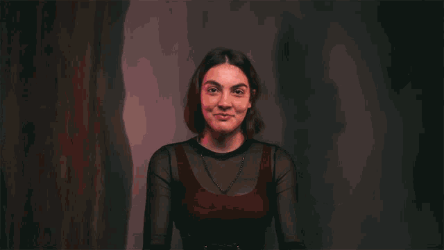 a woman making a funny face with her hands in the air
