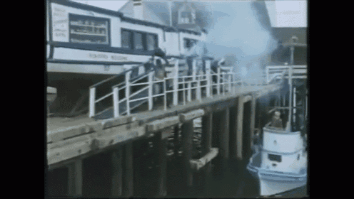 a boat is docked in front of a building that says ' king 's building ' on it