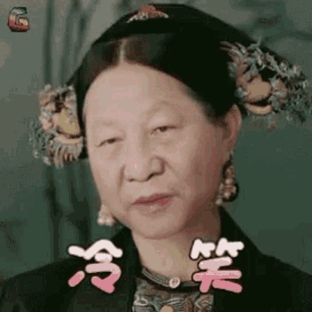 a woman in a traditional costume is making a funny face with chinese writing on her face .