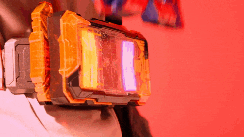 a person is wearing a yellow and black item with a red light coming out of it .