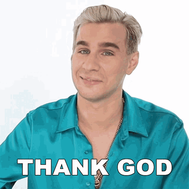 a man wearing a blue shirt with the words thank god on it