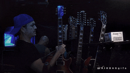 a man playing a guitar next to a box of energizer