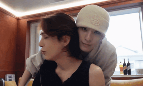 a man wearing a white beanie with the letter h on it