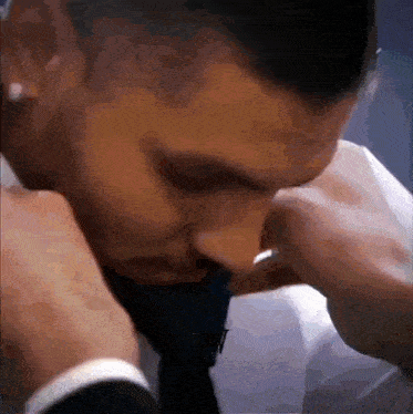 a close up of a man 's face with a tie on