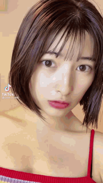a close up of a woman 's face with a tiktok logo on the bottom