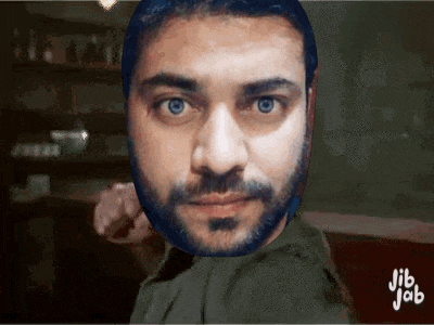 a man with a beard and blue eyes is pointing at the camera ..