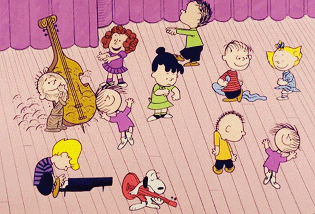 a group of peanuts characters are dancing on a wooden floor