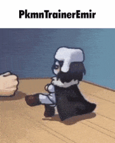 a cartoon character is sitting on a wooden floor next to a fist and the words pkmn trainer emir .