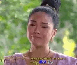 a woman in a purple dress is crying with the number 33 on the bottom right
