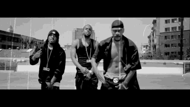 a group of men standing next to each other with one wearing a s on his shorts