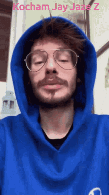 a man wearing glasses and a blue hoodie has the words kocham jay jaze z above his head