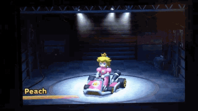 a video game screen shows princess peach in a pink kart