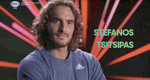 a man with curly hair wearing an adidas shirt