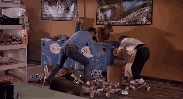 a group of people fighting over a pepsi machine