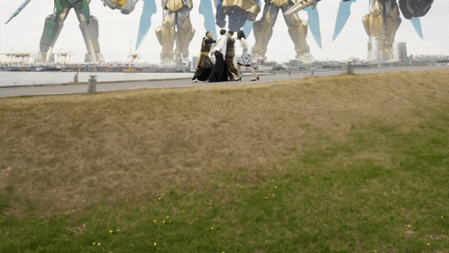 a group of people walking in front of a large robot painting