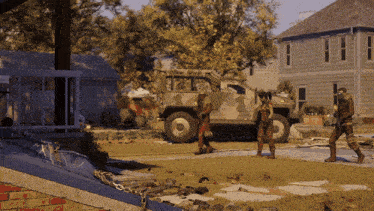 a group of people standing in front of a military truck
