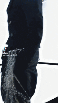 a man wearing sunglasses and a black jacket has tiktok written on the bottom