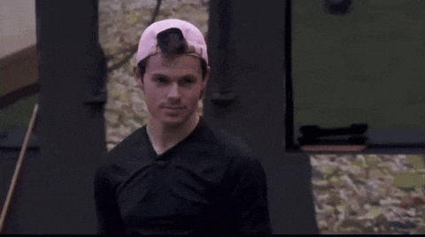 a man wearing a pink hat and black shirt