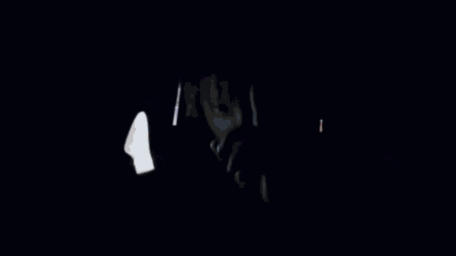 a man with dreadlocks is looking at the camera while holding his hand to his face .