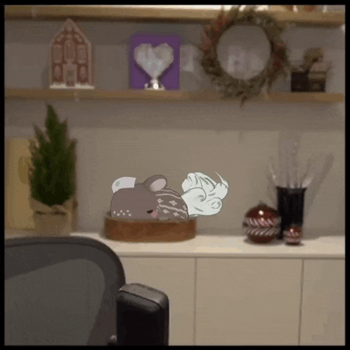 a cartoon of a deer is sitting on a wooden box on a counter .