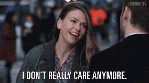 a woman is smiling at a man and saying `` i don t really care anymore . ''