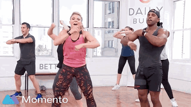 a group of people are dancing in front of a sign that says " daisy butt "