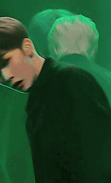 a close up of a person 's face in a green light