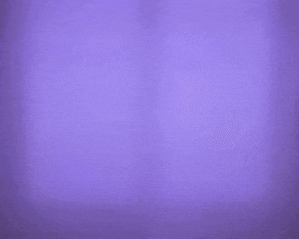 a person is touching another person 's face in a purple light .