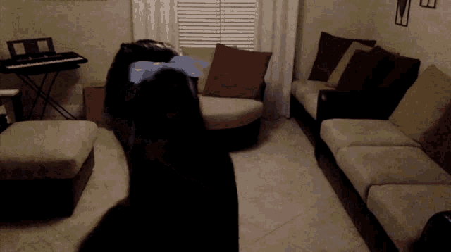 a living room with a couch and a piano