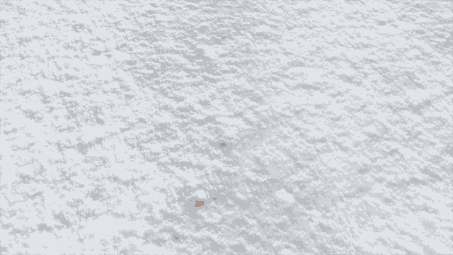 a red brick is laying on a snowy surface