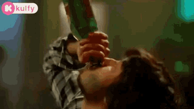 a man is drinking a bottle of soda from a bottle .