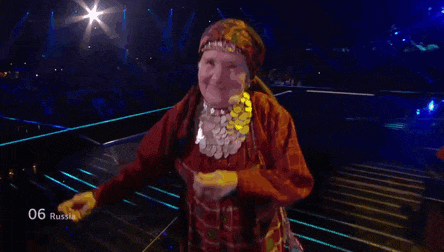 a woman in a red dress is dancing on a stage with the number 06 russia written on the bottom