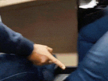 a close up of a person pointing at something