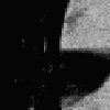 a black and white photo of a person 's face with a red eye and a black background .
