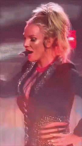 a woman in a black dress with rhinestones on the sleeves