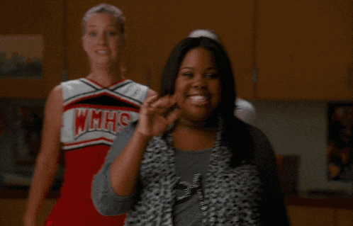 a group of cheerleaders wearing wmhs uniforms standing next to each other