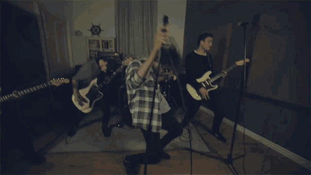a group of people playing guitars in a room