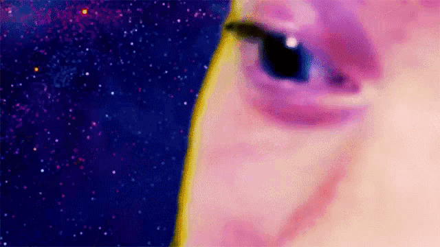 a close up of a person 's eye with a purple background