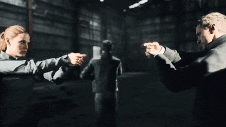 a man and woman pointing at each other in a dark room