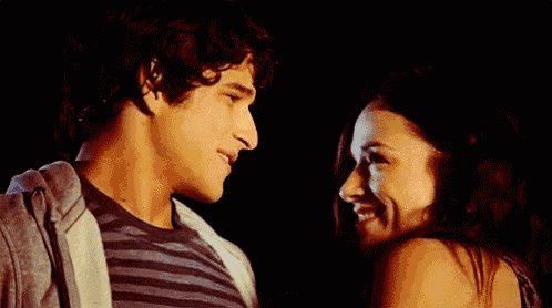 a man and a woman are looking at each other .