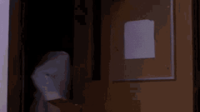 a person is laying on a bed with a glowing light coming out of it .