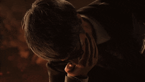 a man 's hand is covered in blood and has a few spots of blood on it