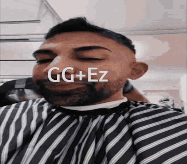 a man with a beard is wearing a black and white striped cape with the words gg + ez written on it
